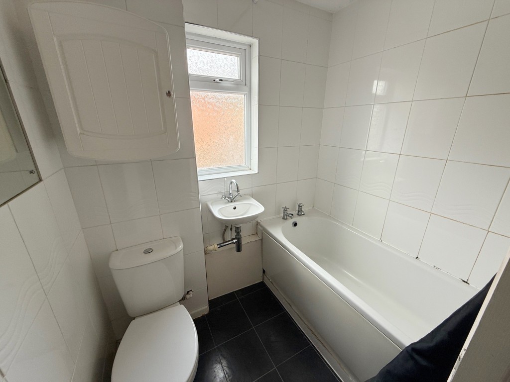 Lot: 6 - END-TERRACE HOUSE FOR IMPROVEMENT - Bath with shower over and toilet plus wash hand basin